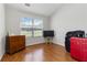 Cozy bedroom with natural light, hardwood floors, and simple furnishings, perfect for relaxation at 5351 Paramount View Way, Sugar Hill, GA 30518