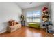 Bright room with hardwood floors, large windows, and neutral walls, awaiting your personal touch at 5351 Paramount View Way, Sugar Hill, GA 30518