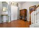 Inviting foyer featuring beautiful hardwood floors, elegant decor, and staircase access to the upper level at 5351 Paramount View Way, Sugar Hill, GA 30518