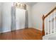 Inviting entryway with hardwood floors and charming decor leading to the staircase at 5351 Paramount View Way, Sugar Hill, GA 30518