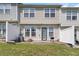 Townhouse exterior featuring a private patio and fenced yard, perfect for relaxation and entertaining at 5351 Paramount View Way, Sugar Hill, GA 30518