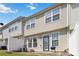 Rear exterior view of townhome with white vinyl fence and small patio at 5351 Paramount View Way, Sugar Hill, GA 30518