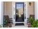 Inviting front porch with chairs, planters, and a welcome mat leading to the front door with sidelights at 5351 Paramount View Way, Sugar Hill, GA 30518