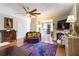 Living room features a fireplace, a decorative rug, and a purple sofa with decorative pillows at 5351 Paramount View Way, Sugar Hill, GA 30518