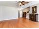 View of the living room featuring hardwood floors, a ceiling fan, and elegant decor at 5351 Paramount View Way, Sugar Hill, GA 30518