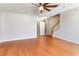 Spacious living room featuring hardwood floors, a ceiling fan, and ample natural light at 5351 Paramount View Way, Sugar Hill, GA 30518