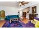 A vibrant living room with colorful seating and rich hardwood flooring in a well-lit space at 5351 Paramount View Way, Sugar Hill, GA 30518