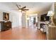 View of the living room showcasing a fireplace, decor, hardwood floors, and ceiling fan at 5351 Paramount View Way, Sugar Hill, GA 30518