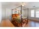 Spacious primary bedroom with a canopy bed, wood floors, and multiple windows for natural light at 5351 Paramount View Way, Sugar Hill, GA 30518