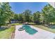 An aerial shot showcases the in-ground pool, hot tub and mature trees at 664 Johnson Rd, Oxford, GA 30054