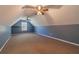 Spacious attic area with unique ceiling, carpet flooring, and a window at 664 Johnson Rd, Oxford, GA 30054