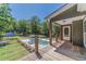 Inviting backyard view from porch showcasing pool, spa, and lush greenery at 664 Johnson Rd, Oxford, GA 30054