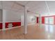 Finished basement with hardwood style floors, red accent wall, and white pillars at 664 Johnson Rd, Oxford, GA 30054