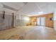 Unfinished basement space with cement walls, wood paneling, and outdoor exit at 664 Johnson Rd, Oxford, GA 30054