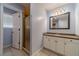 Bathroom with shower, vanity, and tile floor, all illuminated by natural light at 664 Johnson Rd, Oxford, GA 30054