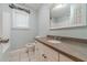 Cozy bathroom featuring a granite countertop, vanity, and well-lit mirror at 664 Johnson Rd, Oxford, GA 30054