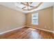 Bright bedroom with hardwood floors, neutral walls, and a modern ceiling fan at 664 Johnson Rd, Oxford, GA 30054