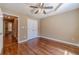 Spacious bedroom with hardwood floors, ample closet space, and ceiling fan at 664 Johnson Rd, Oxford, GA 30054