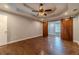 Neutral bedroom with hardwood floors, sliding barn doors, and ceiling fan at 664 Johnson Rd, Oxford, GA 30054