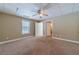Large bedroom featuring carpet flooring, ceiling fan, and multiple closets at 664 Johnson Rd, Oxford, GA 30054