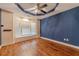 Bright bedroom with bay window, hardwood floors, ceiling fan, and decorative trey ceiling at 664 Johnson Rd, Oxford, GA 30054