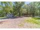 Exterior view showing gravel parking area, outbuildings and forest at 664 Johnson Rd, Oxford, GA 30054