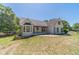 Charming home featuring a white painted brick exterior, black shutters, and a lovely front lawn at 664 Johnson Rd, Oxford, GA 30054