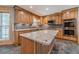 Kitchen featuring granite counters, stainless steel appliances, custom cabinets, and center island at 664 Johnson Rd, Oxford, GA 30054