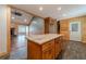 Open kitchen with center island, leading to living area, wood cabinetry, and hardwood floors at 664 Johnson Rd, Oxford, GA 30054