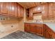 Cozy laundry room with wood-paneled walls, cabinets, and tile flooring at 664 Johnson Rd, Oxford, GA 30054