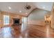 Spacious living room featuring hardwood floors, a stone fireplace, and wood paneled walls at 664 Johnson Rd, Oxford, GA 30054
