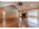This cozy living room showcases a stone fireplace, hardwood floors, and natural light at 664 Johnson Rd, Oxford, GA 30054