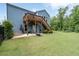 Well-maintained backyard featuring a cozy patio, wooden deck, and ample green space at 7430 Ramsgate Ct, Cumming, GA 30040