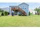 Large backyard offering a wooden deck, patio area, and plenty of room for recreation at 7430 Ramsgate Ct, Cumming, GA 30040