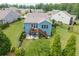 Spacious backyard with a deck, patio, and lush lawn, perfect for outdoor entertaining at 7430 Ramsgate Ct, Cumming, GA 30040