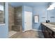 Bright bathroom with a tiled shower, granite countertops, and a modern towel warmer at 7430 Ramsgate Ct, Cumming, GA 30040