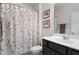 Bathroom features a vanity with dark wood cabinets and a decorative shower curtain at 7430 Ramsgate Ct, Cumming, GA 30040