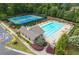 Community pool and tennis courts surrounded by mature trees, offering a resort-like experience at 7430 Ramsgate Ct, Cumming, GA 30040