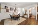Dining room showcases hardwood floors, decor shelving, and a wooden table with modern style chairs at 7430 Ramsgate Ct, Cumming, GA 30040