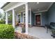 Inviting front porch featuring classic columns, comfortable seating, and tasteful decor for relaxation and curb appeal at 7430 Ramsgate Ct, Cumming, GA 30040