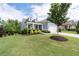 Beautiful blue home showcasing a well-manicured lawn, tasteful landscaping, and a welcoming two-car garage at 7430 Ramsgate Ct, Cumming, GA 30040