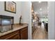 Hallway view with marble counters, dark wood cabinets, and an ice maker leading into the kitchen at 7430 Ramsgate Ct, Cumming, GA 30040