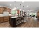 Open concept kitchen features stainless steel appliances, a center island with seating, and ample cabinet space at 7430 Ramsgate Ct, Cumming, GA 30040