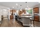 Bright, open kitchen with hardwood floors, stainless appliances, island with seating, and ample counter space at 7430 Ramsgate Ct, Cumming, GA 30040