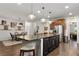 Spacious kitchen island with barstool seating and stylish pendant lights overlooking the adjacent dining area at 7430 Ramsgate Ct, Cumming, GA 30040