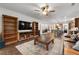 Bright living room featuring hardwood floors, built-in shelving, and a comfortable leather couch at 7430 Ramsgate Ct, Cumming, GA 30040
