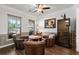 Cozy living room features hardwood floors, a ceiling fan, and comfortable seating for entertaining guests at 7430 Ramsgate Ct, Cumming, GA 30040