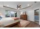 Bright main bedroom featuring hardwood floors, a tray ceiling, and natural light at 7430 Ramsgate Ct, Cumming, GA 30040