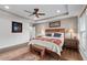 Spacious main bedroom with hardwood floors, a tray ceiling, and an inviting wood frame bed at 7430 Ramsgate Ct, Cumming, GA 30040