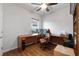 Well-lit home office featuring hardwood floors, a large wooden desk, and an ergonomic chair at 7430 Ramsgate Ct, Cumming, GA 30040